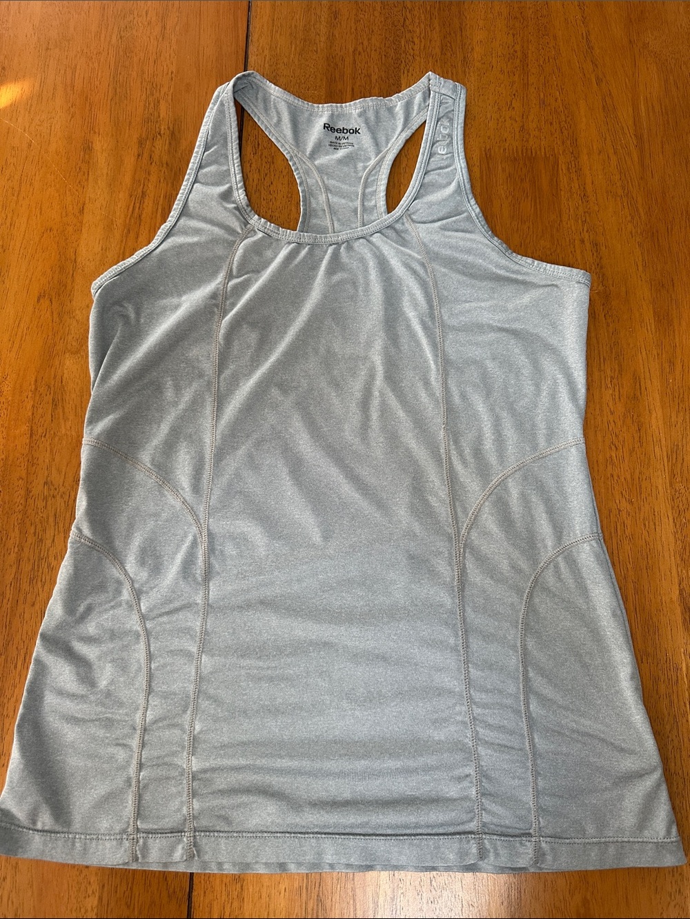 Reebok women’s light gray racerback workout shirt.